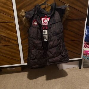 Women’s camo print Canada puffer vest with fur trim.